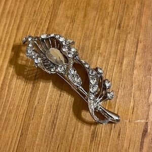 Vintage fancy flower on silver tone brooch with rhinestones 2 1/4”